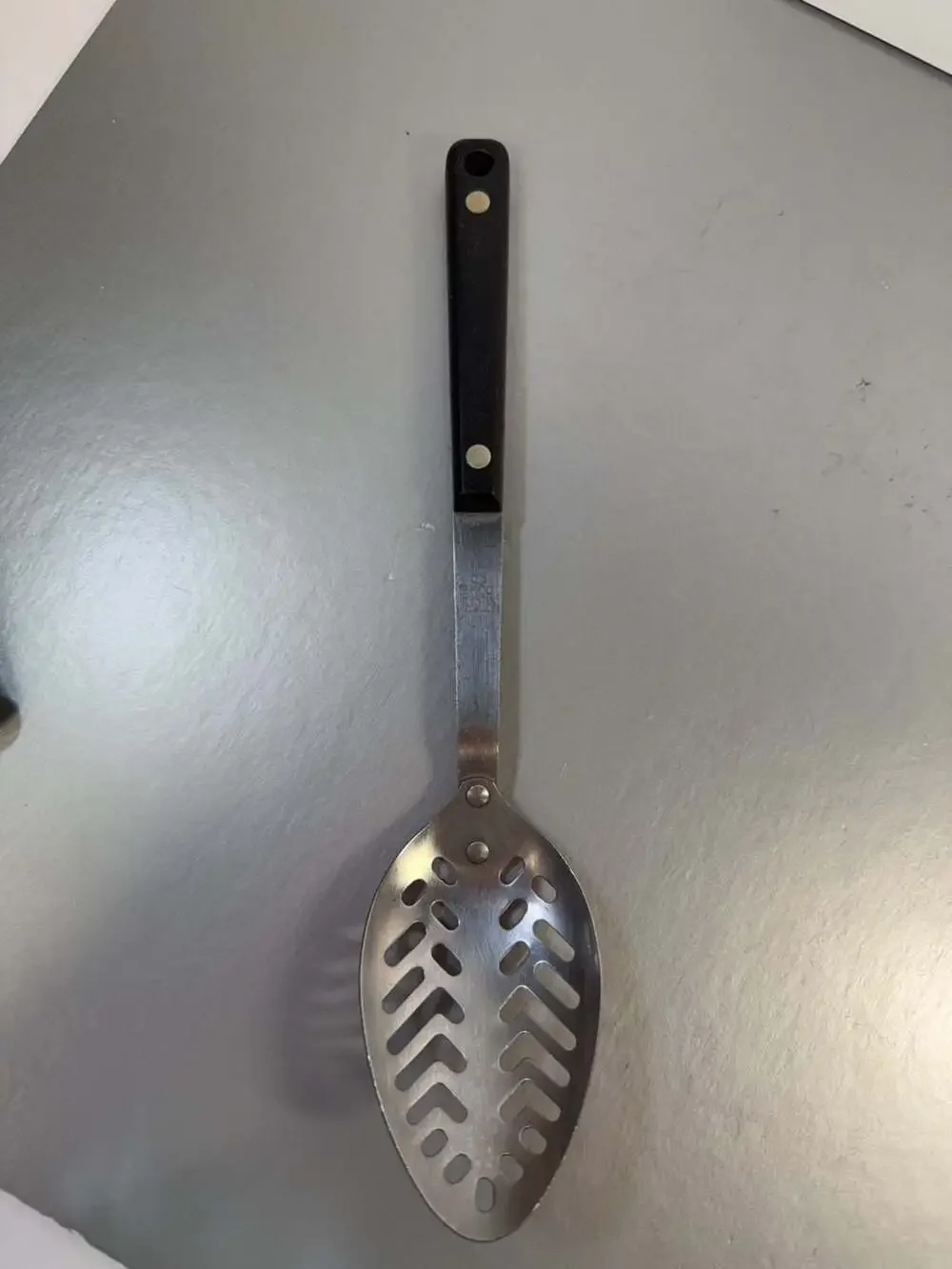 Vintage Ekco Stainless Vanadium Slotted Serving Spoon with Black Composite Handl